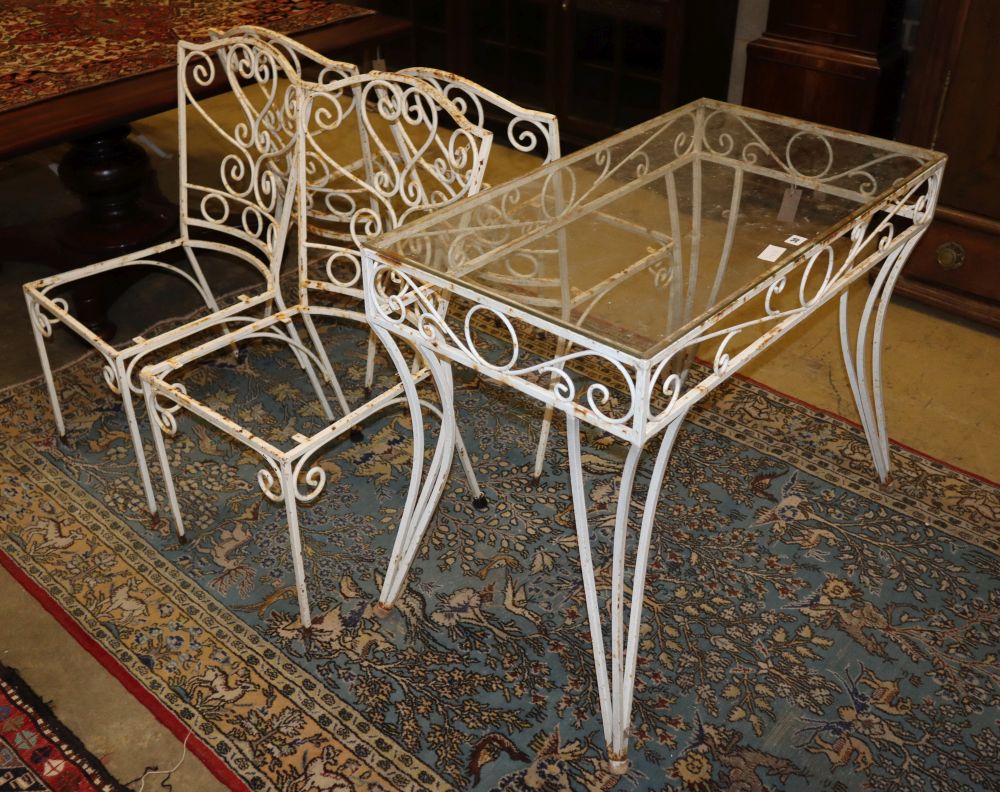 A glass top painted wrought iron garden table, W.91cm, D.50cm, H.74cm together with four chairs (no seats)
